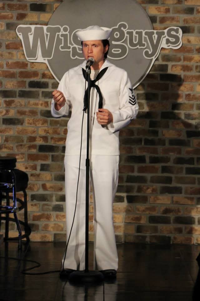 J'myle Koretz on stage at Wiseguys Comedy Club in full Navy crackerjacks